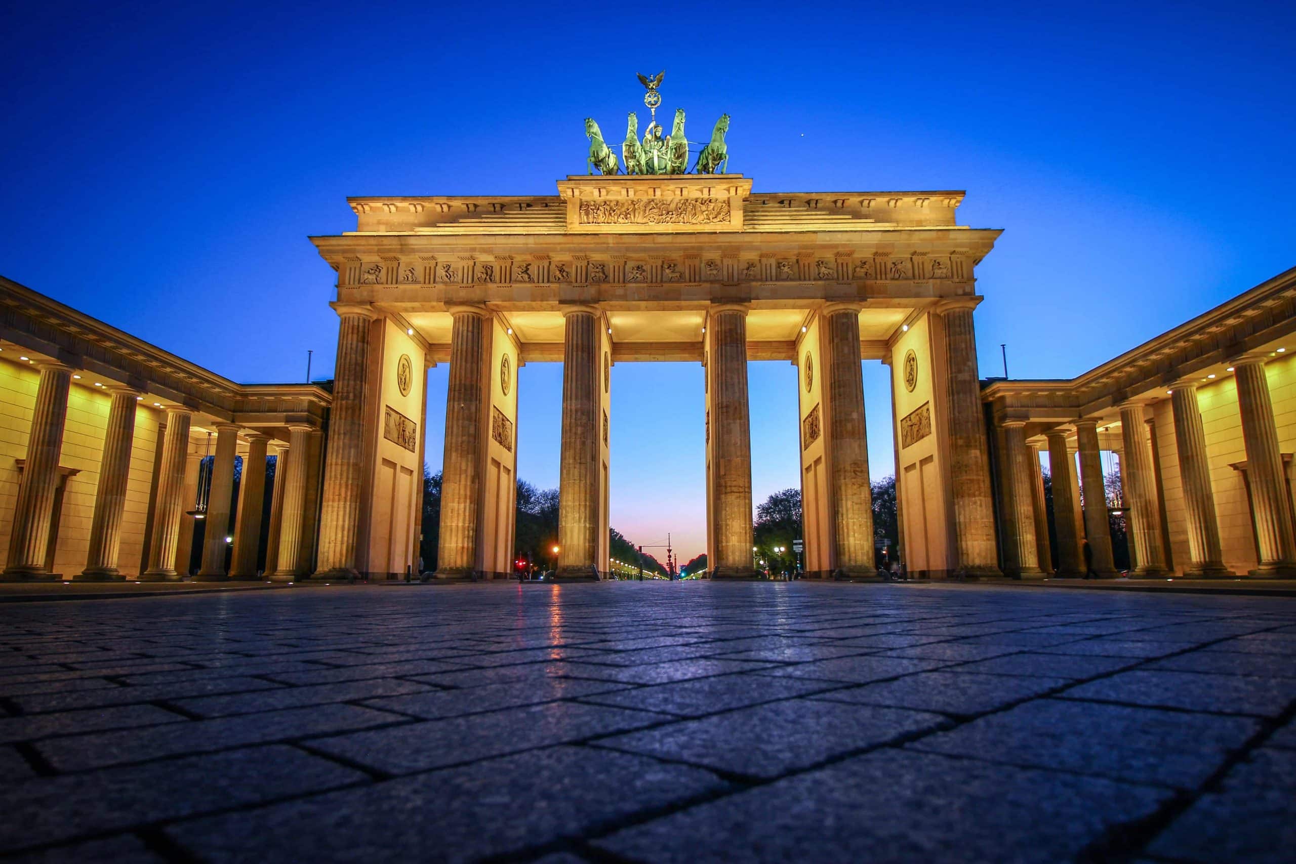Large 6 columned marble gate with bronze statue above the middle arch